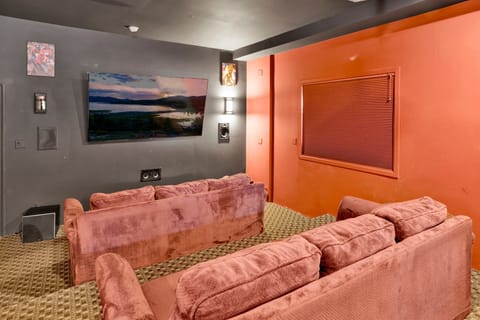 Dedicated home theater with surround sound and reclining chairs, designed for immersive entertainment