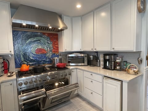 The Thermador range with oven, convection, steam oven, double griddle, 6 burner stove top and pot filler will make any large meal prep easier.