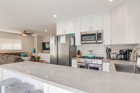 Newly remodeled kitchen with quartz counters and stainless steel appliances