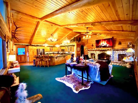 soaring ceilings in the living room with an open floorplan with an 85inches TV 