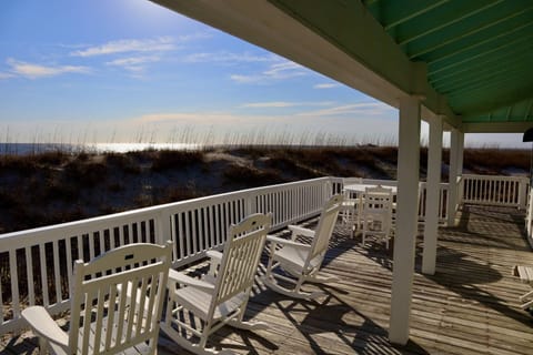 Large deck with rocking chairs and dining option