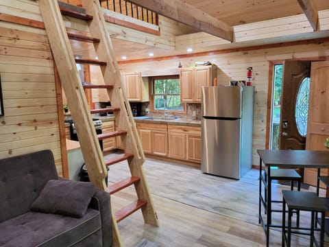 view from living room showing ship ladder to access loft
