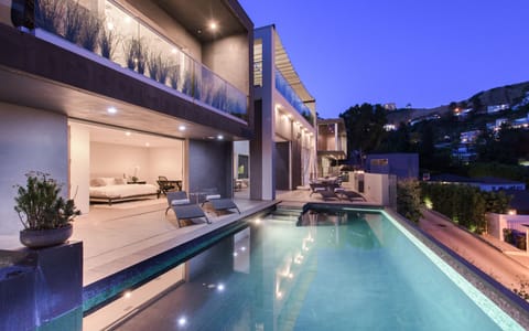 The home illuminates at night, showcasing beautiful lighting