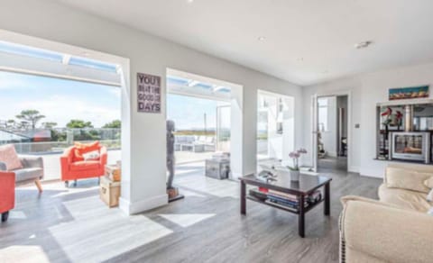 Sun lounge with conservatory , bi fold doors open onto sun terrace 