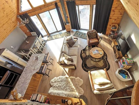 View from the top of the spiral stairs: Living room and kitchen. All levels now have LVP flooring instead of carpet.  