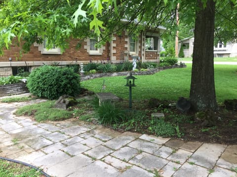 Double lot yard and shade gardens along limestone patio