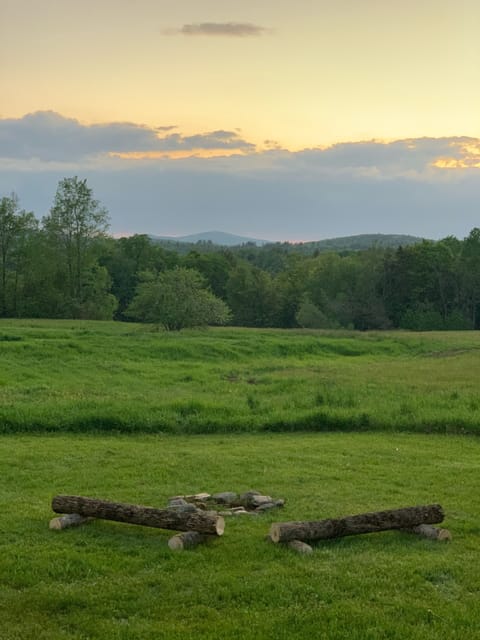 Fire pit in back yard overlooking fields and mountains