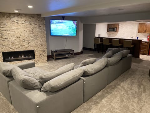 Comfy and spacious family room with kitchenette, ping pong table, & fireplace.