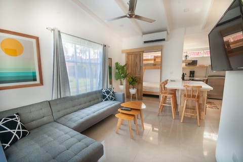 Comfortable, modern living area with 42” smart TV, and AC