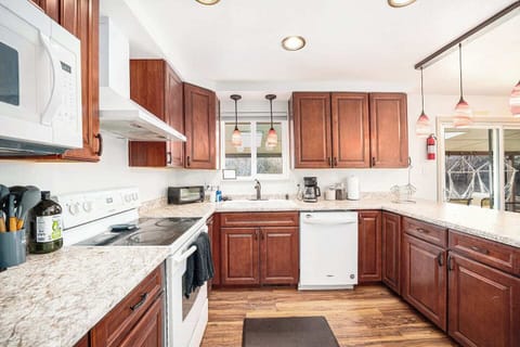 - Spacious countertops and plenty of storage await your inner chef’s creativity
- Brew your morning coffee with a view and start the day in this sunlit space
- Chic pendant lights and patio access make this kitchen the heart of the home