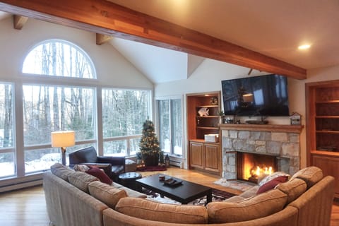 Inviting, open concept family room with gas fireplace and 65" flat screen tv