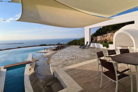 Outdoor dining and lounge area with panoramic sea views