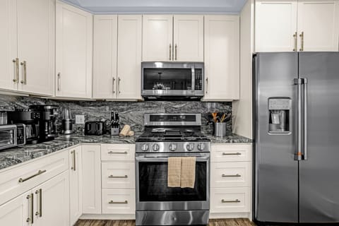 Kitchen has many appliances, including a Keurig and standard coffee pot.  