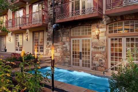 Soak in steamy waters while flames flicker beside you