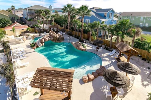 Heated resort-style pool with slide and palapas