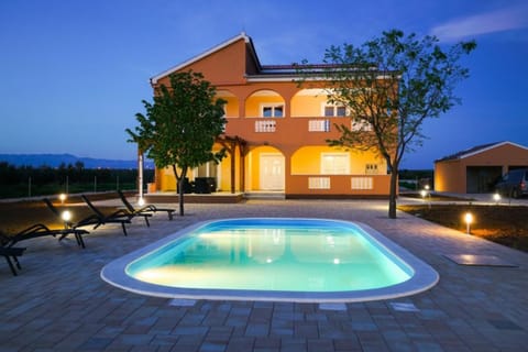 Exterior with pool at night