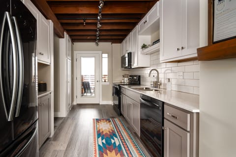 Full kitchen with access to a small outdoor porch.