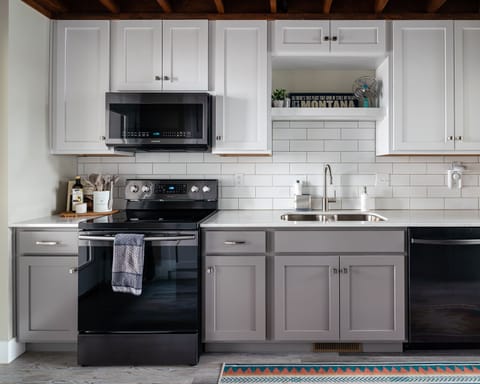 Full modern kitchen with plenty of cookware.