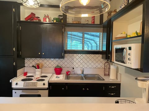 Small kitchenette with electric vintage stove and oven, microwave, and refrig!
