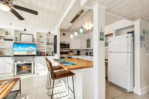 Kitchen Paradise: Bright and airy kitchen with bar seating, coastal decor, and modern amenities!