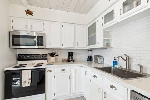 Kitchen: Whip up culinary delights in this bright, modern space with sleek amenities and beachy decor!