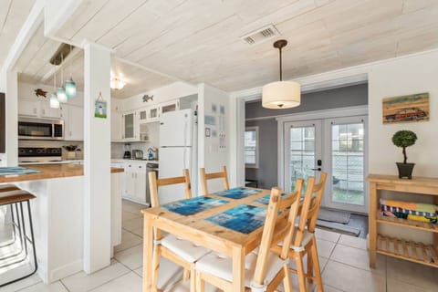 Dining Room: Enjoy meals at a vibrant table while basking in natural light and coastal decor!