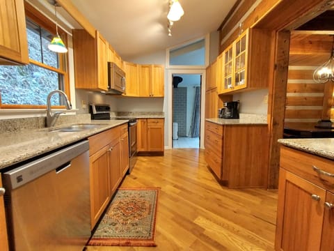 The fully stocked modern kitchen includes a dishwasher and granite counters.