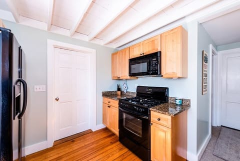 Stove / Oven / Microwave and door to bedroom (queen)