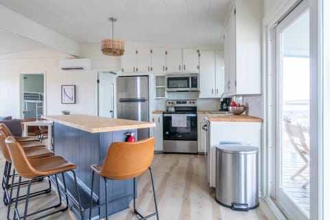 Newly renovated kitchen. All new stainless steel appliances. Butcher block bar that seats 5, plus table that seats 4.