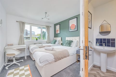 Bedroom 1 has a work desk, en-suite shower and a comfortable zip-link bed which is configured as two single beds by default or can be zipped together to form a king-size bed upon request.