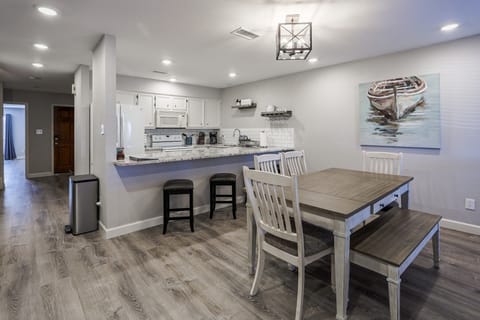 Enjoy mealtime at the farmhouse-style dining table or eat-in bar