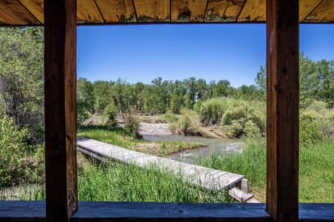 Looking out from porch - foot bridge across Cottonwood Creek to Gallatin River