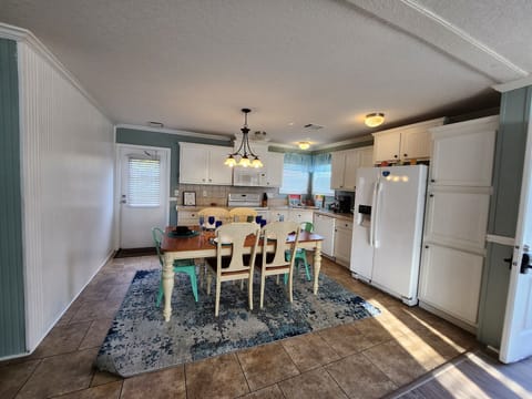 Full kitchen with glass top stove and oven, dishwasher and more.