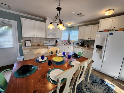 Full kitchen with glass top stove and oven, dishwasher and more.