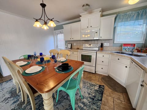 Full kitchen with glass top stove and oven, dishwasher and more.