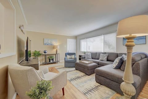 Living Room: Brightly lit living room with a view of the bay.  Features a sectional sofa bed that makes into a queen bed plus a comfy swivel rocking chair. 
