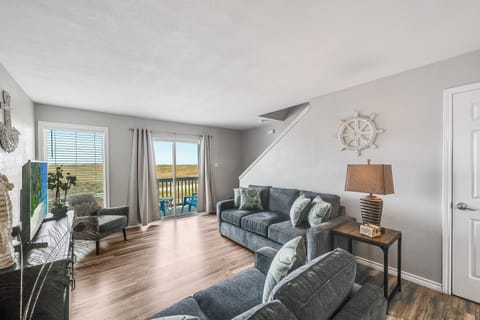 Relax in your bright living room with comfortable seating and scenic views through sliding doors to your private balcony.