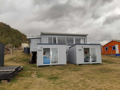 The two pods with the bach in the background