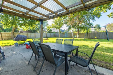 Covered patio with view over the yard and charcoal grill
