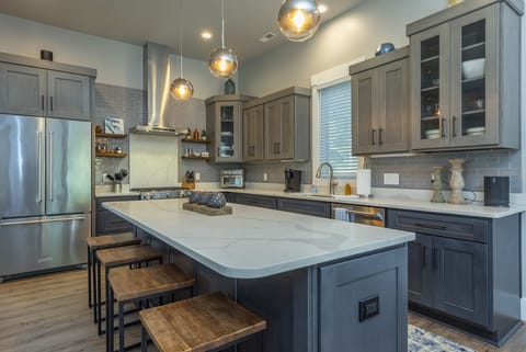 Gourmet kitchen with island seating for 4, gas range stove, Keurig coffeemaker & Sonos Sound System.