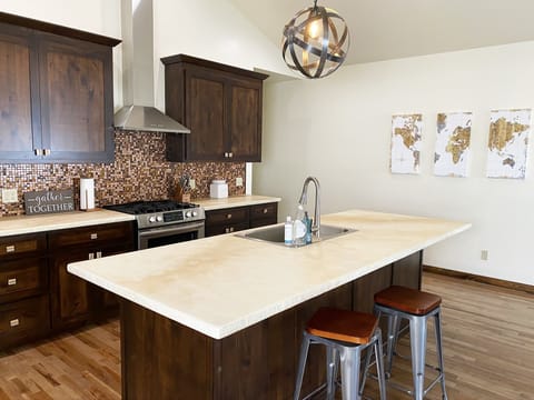 Kitchen—Equipped with a stainless steel propane oven and stovetop