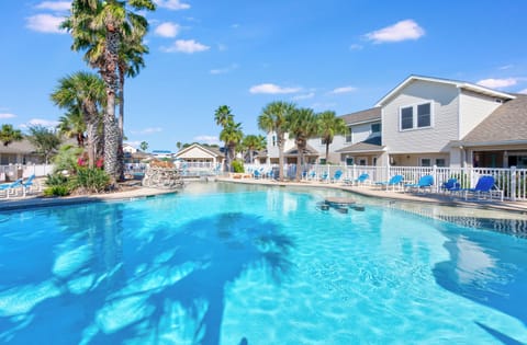 Crystal-clear waters invite you to dive into paradise, surrounded by swaying palms and sunny skies.