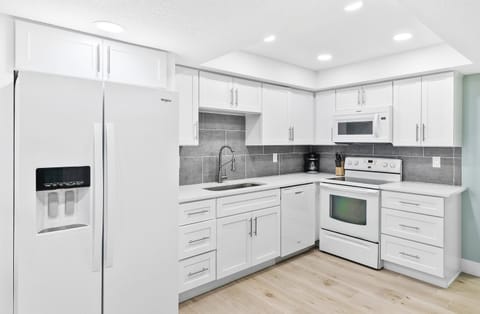 Sleek white cabinetry and stainless steel appliances