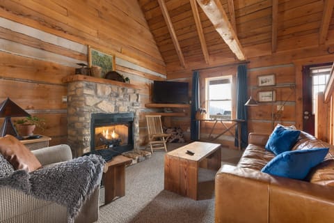 Luxurious designer leather sofa, custom barn wood coffee table and side chairs invite you to gather in front of the gas fireplace. Evenings are cool year round making the fireplace the perfect centerpiece to your gathering space, winter and summer.,