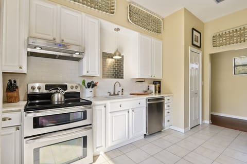 Kitchen appliances include: electric range, dishwasher, refrigerator, and microwave. 