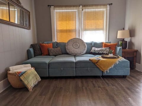 Sleeper sofa in living room (sleeps two). Bedding provided