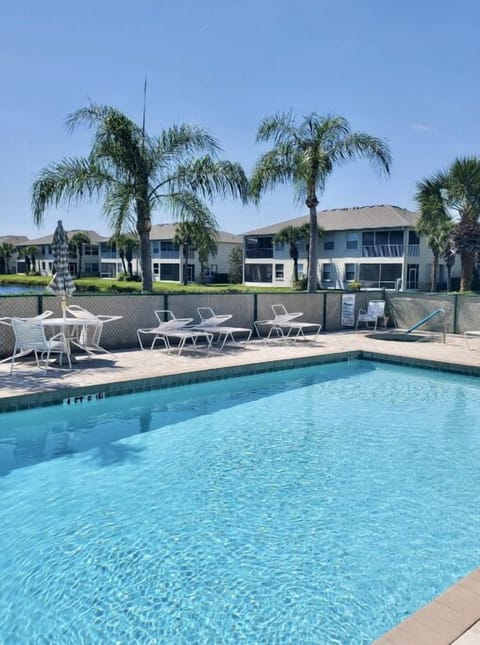 Beautiful pool setting among the palm trees and fountain in adjacent pond.