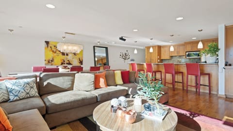 Settle into your spacious open-concept retreat where warm wood tones and vibrant pops of color create the perfect backdrop for memorable gatherings with family and friends.