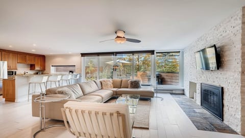 Your spacious open-concept retreat combines living, dining, and kitchen spaces with natural light flooding in through floor-to-ceiling windows. Relax by the fireplace or step onto your private deck.