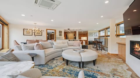 Picture yourself unwinding on plush sofas by the warm fireplace, with ample space to gather, dine, and create memories in this beautifully designed open-concept living area.
